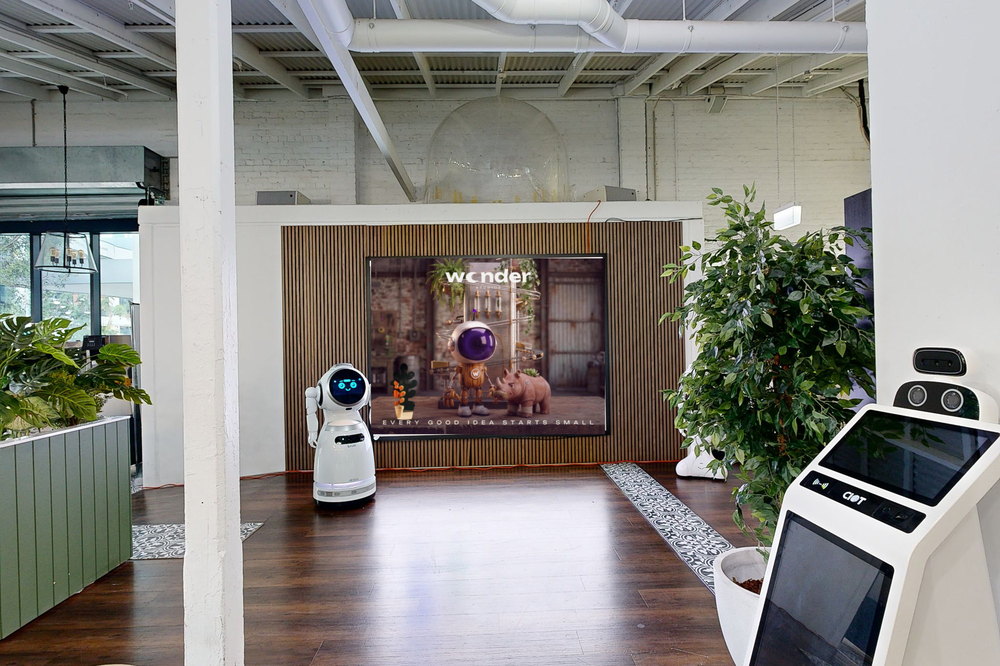 The LED wall between the planters, a service robot either side of it
