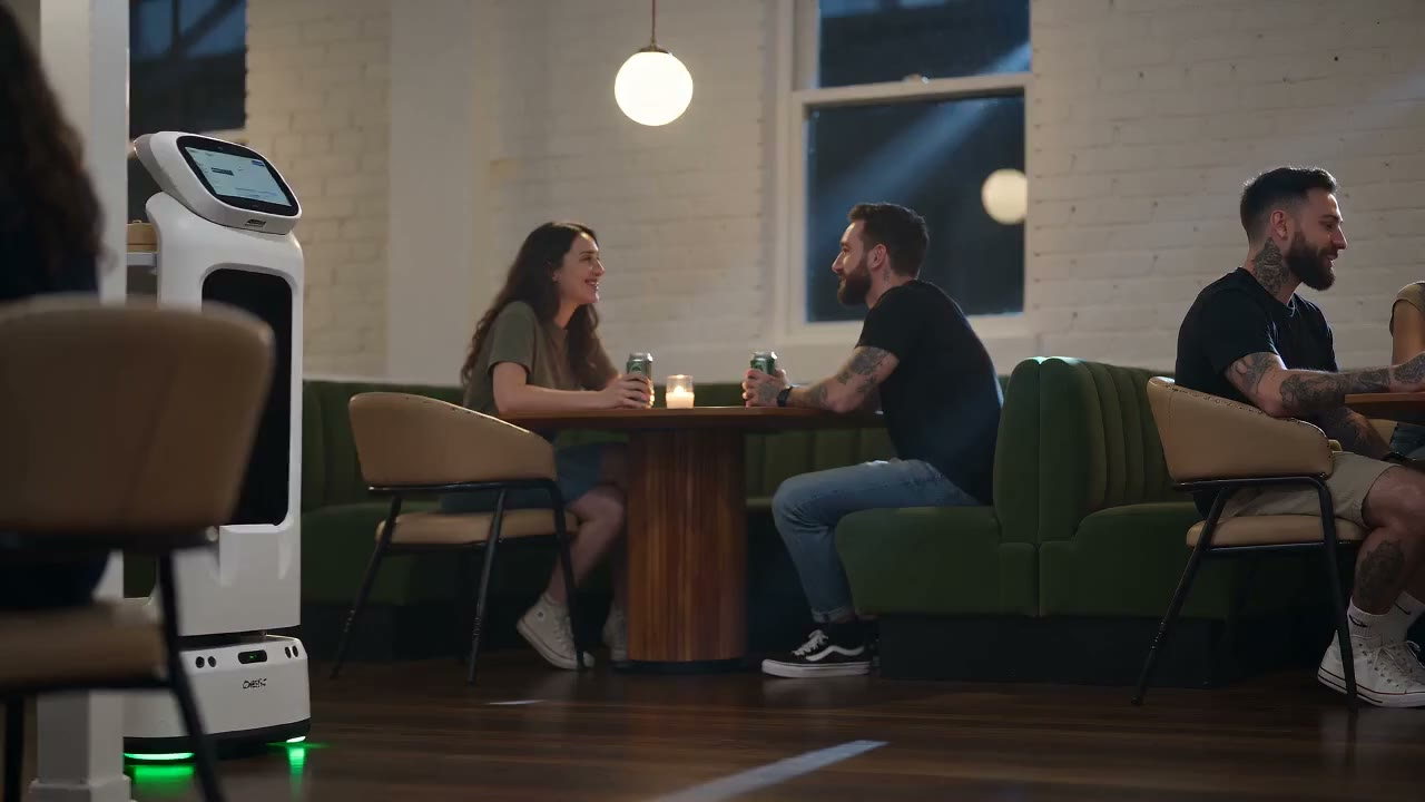 Guests at the booths with a service robot on the floor