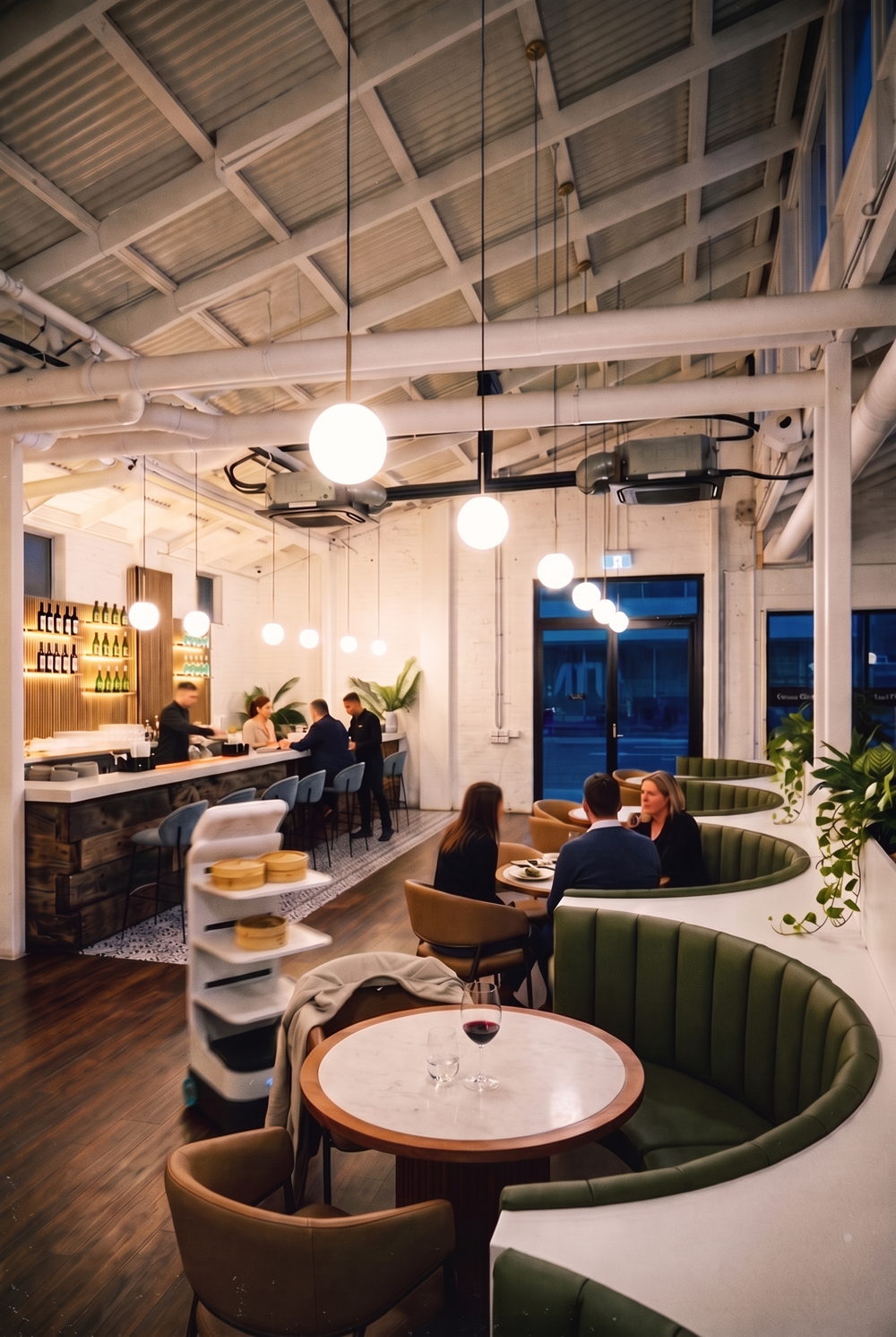 The studio in service: the bar, the booths and a service robot carrying steamers